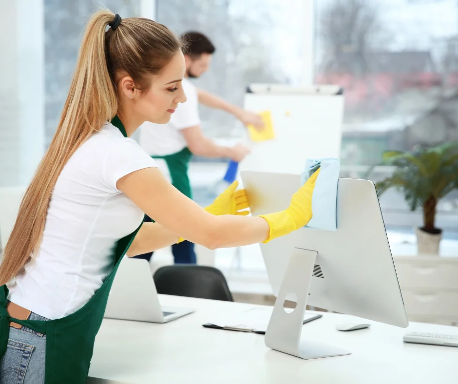 Jiffy Elite Maids team cleaning an upscale office space in Southwest Ranches, Florida—professionals wiping down monitors and desks with eco-friendly supplies and attention to detail.