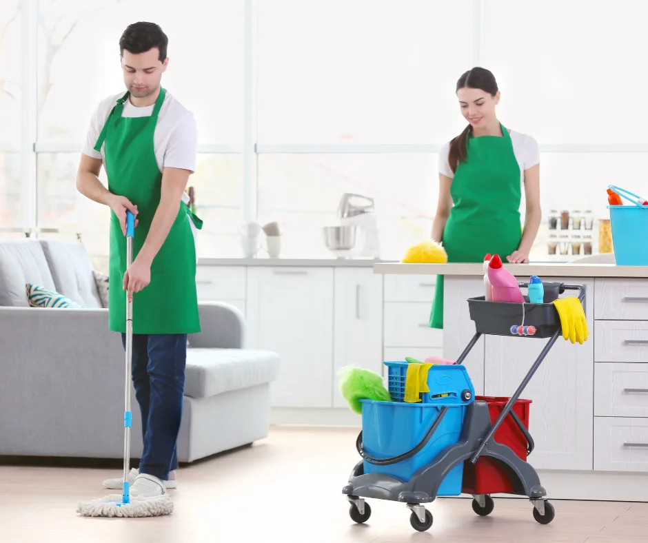 Jiffy Elite Maids team cleaning a modern kitchen and living area in Miramar, Florida, wearing green uniforms and using eco-friendly products.